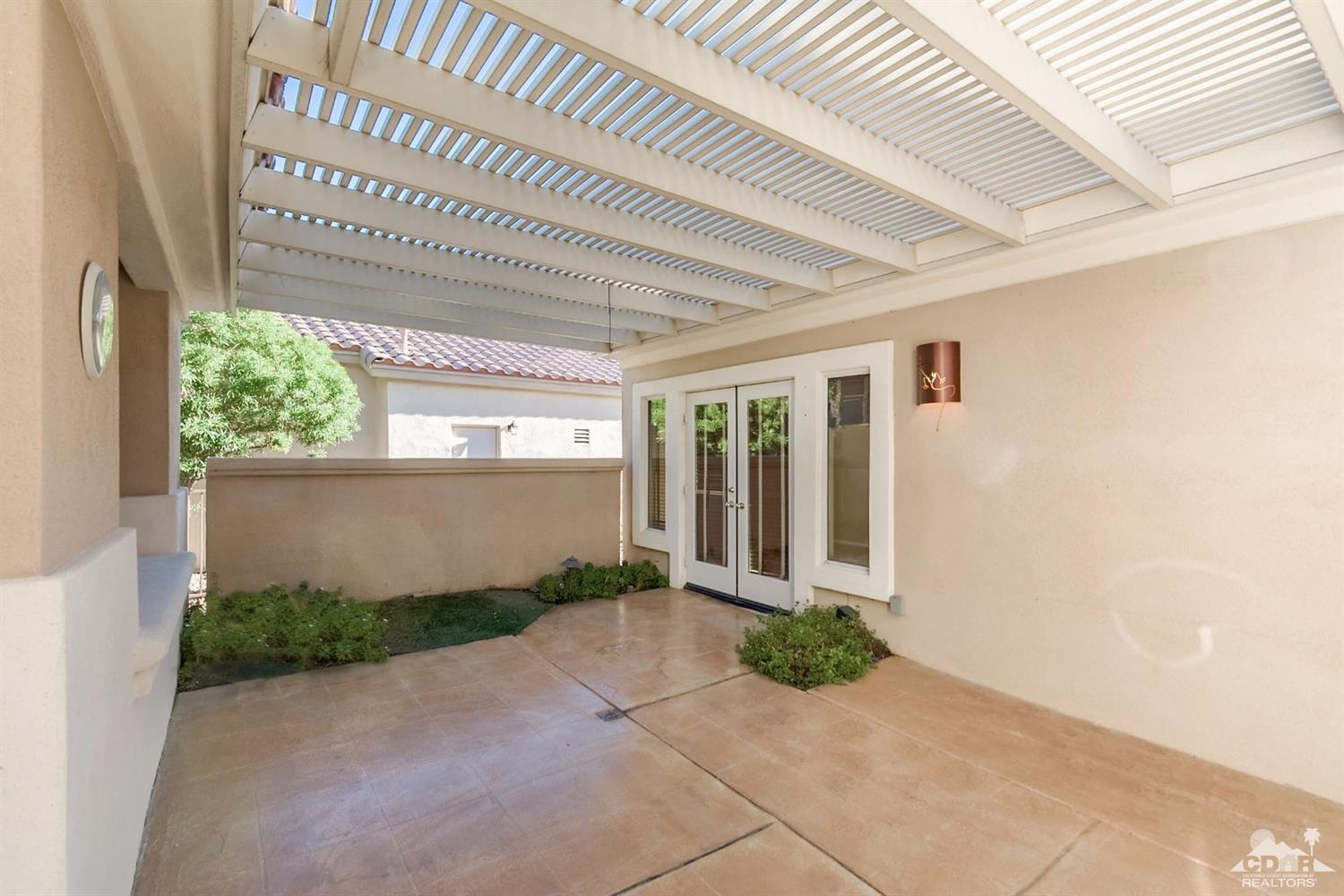 39515 Manorgate Road Palm Desert, CA 92211 - Photo 9 of 42 a view of a house with potted plants in front of door
