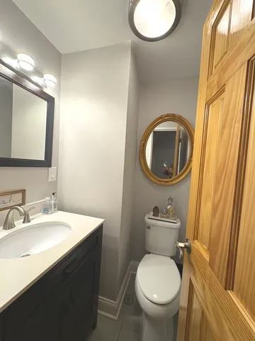 a bathroom with a toilet sink and mirror