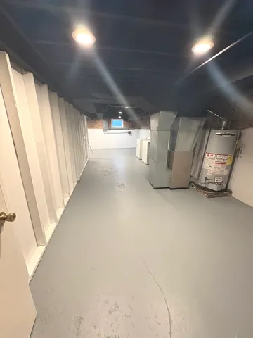 a view of water heater room with stairs