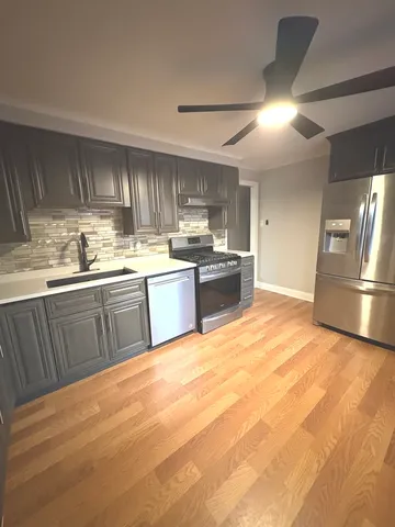 a large kitchen with cabinets and stainless steel appliances