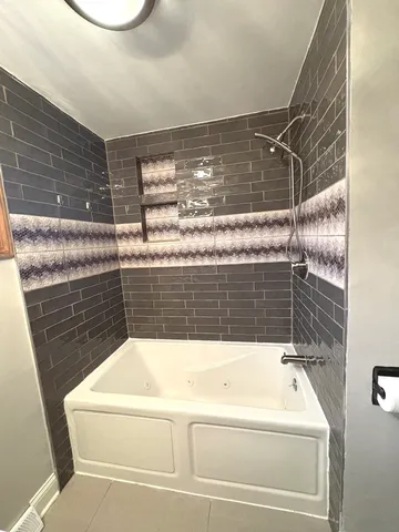 a bathroom with a bathtub and shower