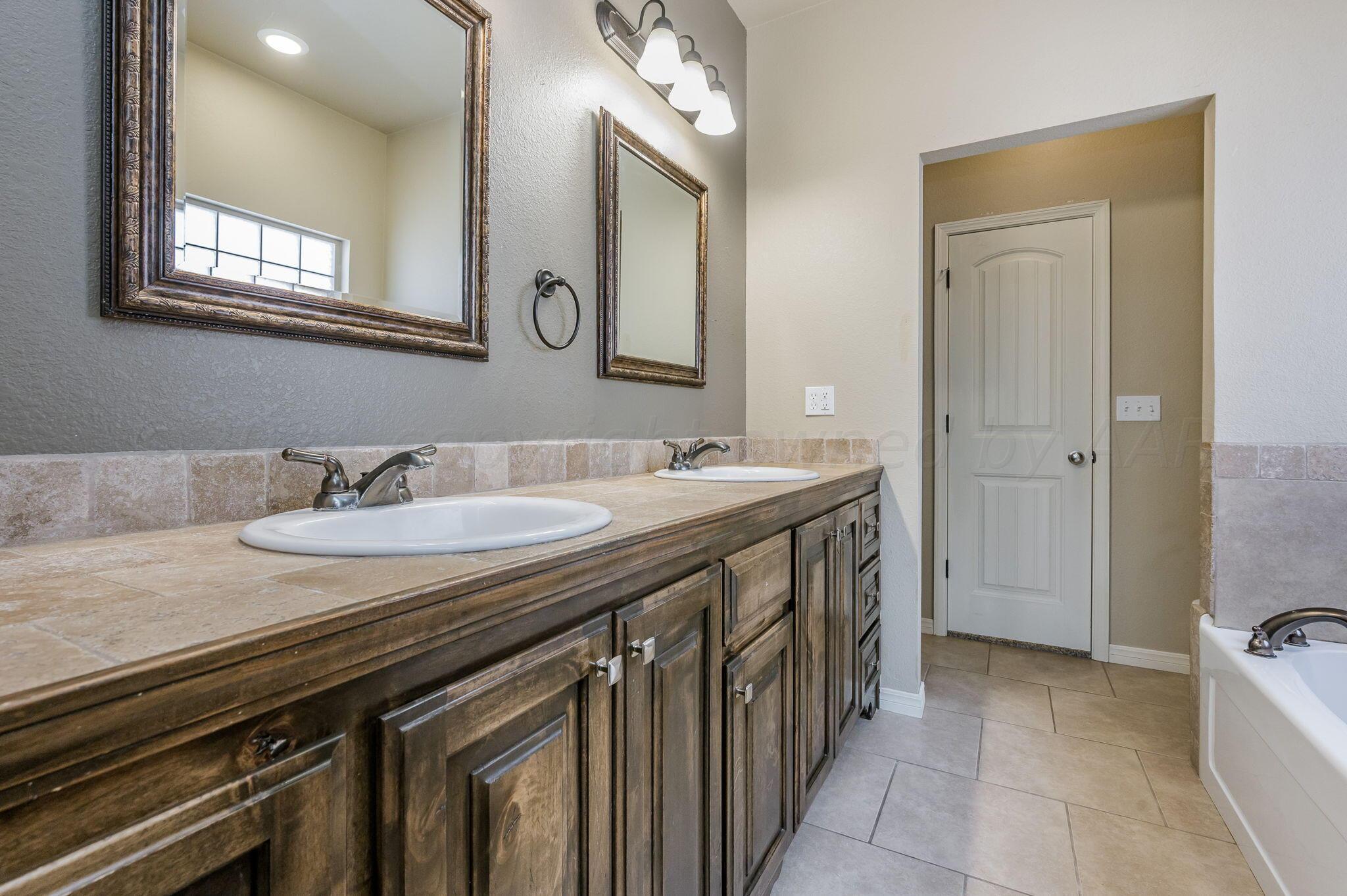 3601 Springfield Avenue Amarillo, TX 79118 - Photo 12 of 26 a bathroom with a sink a vanity and a mirror