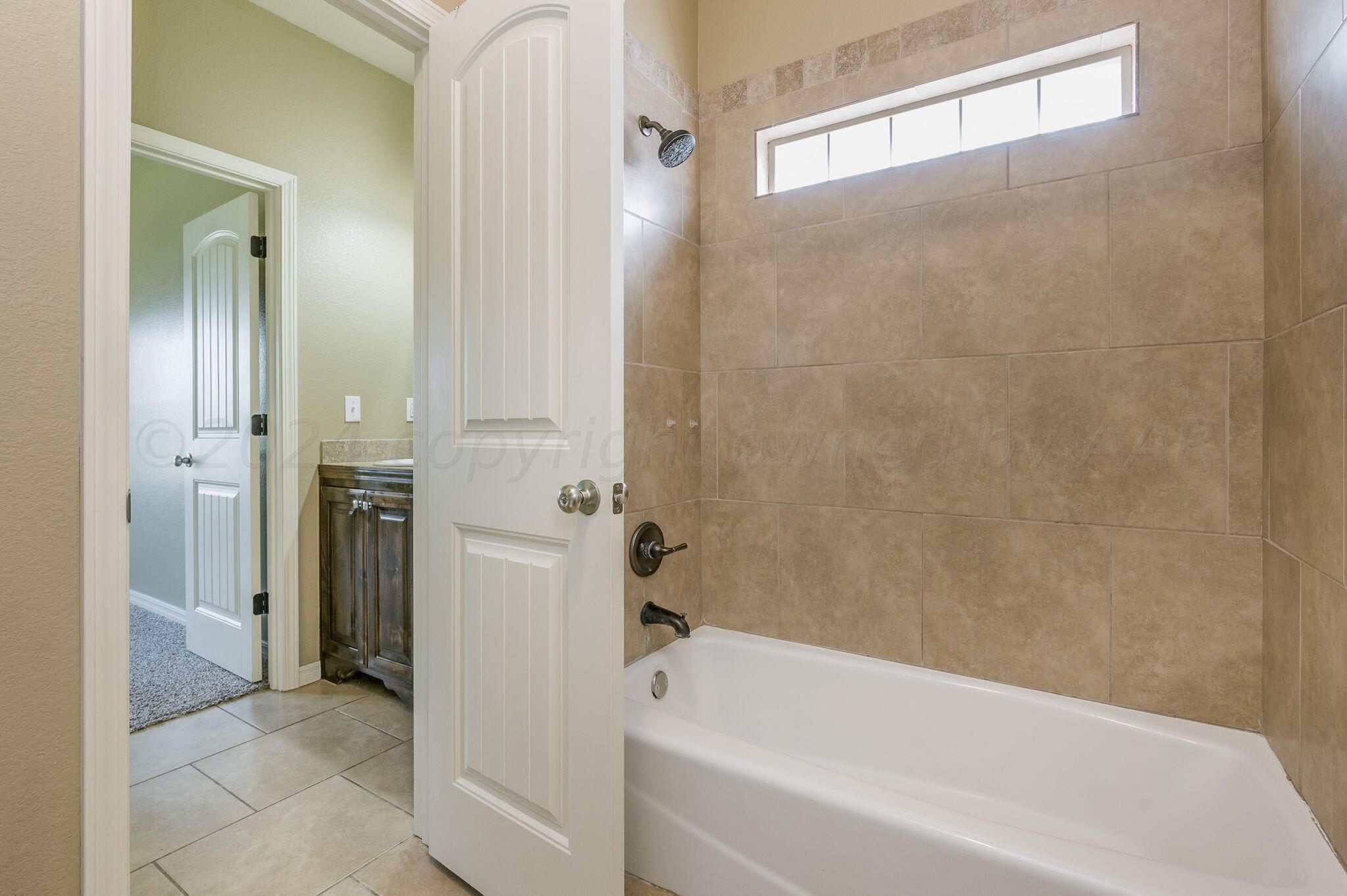 3601 Springfield Avenue Amarillo, TX 79118 - Photo 21 of 26 a bathroom with a bathtub and a shower