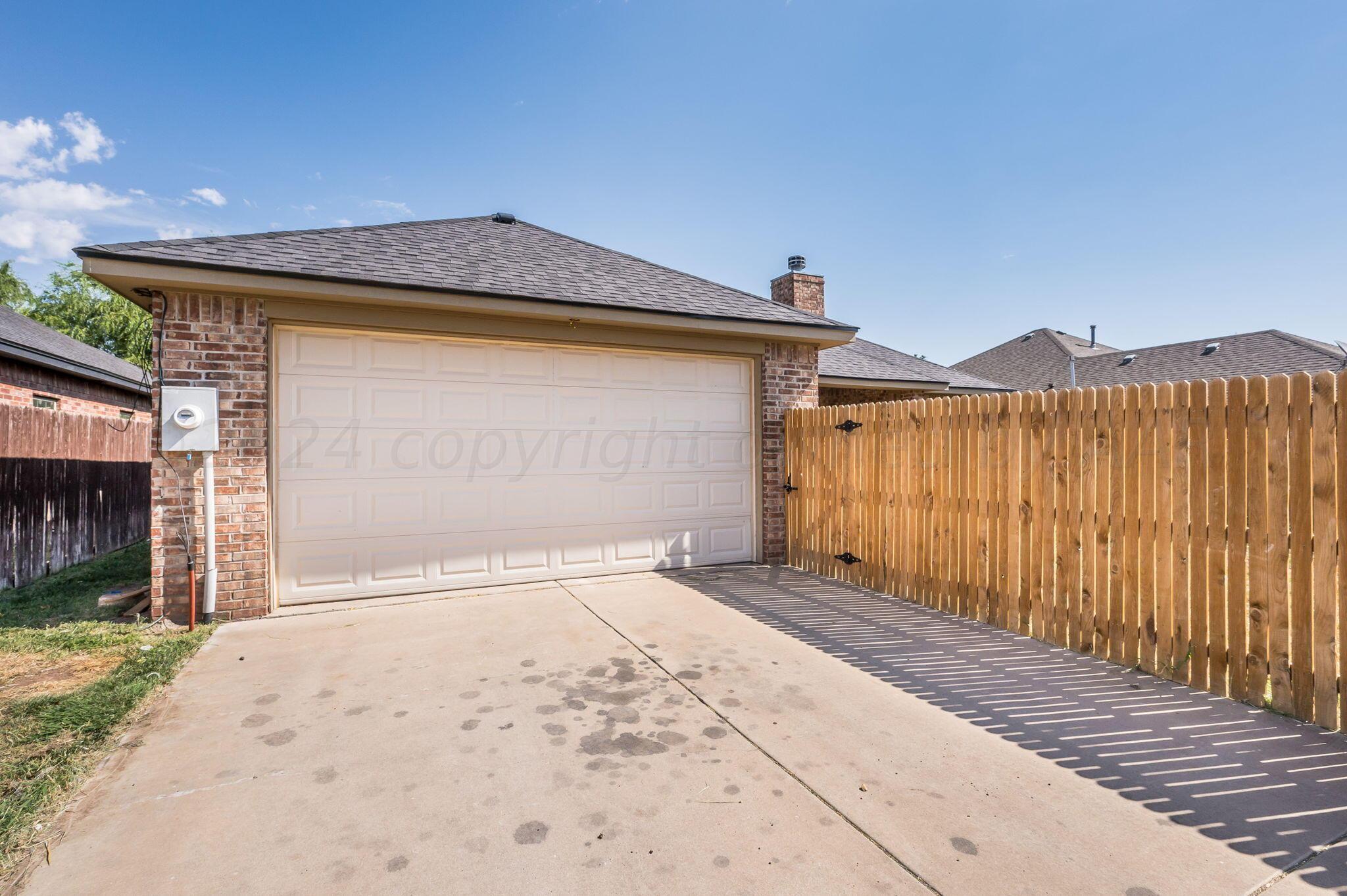 3601 Springfield Avenue Amarillo, TX 79118 - Photo 23 of 26 a front view of a house with a yard and garage