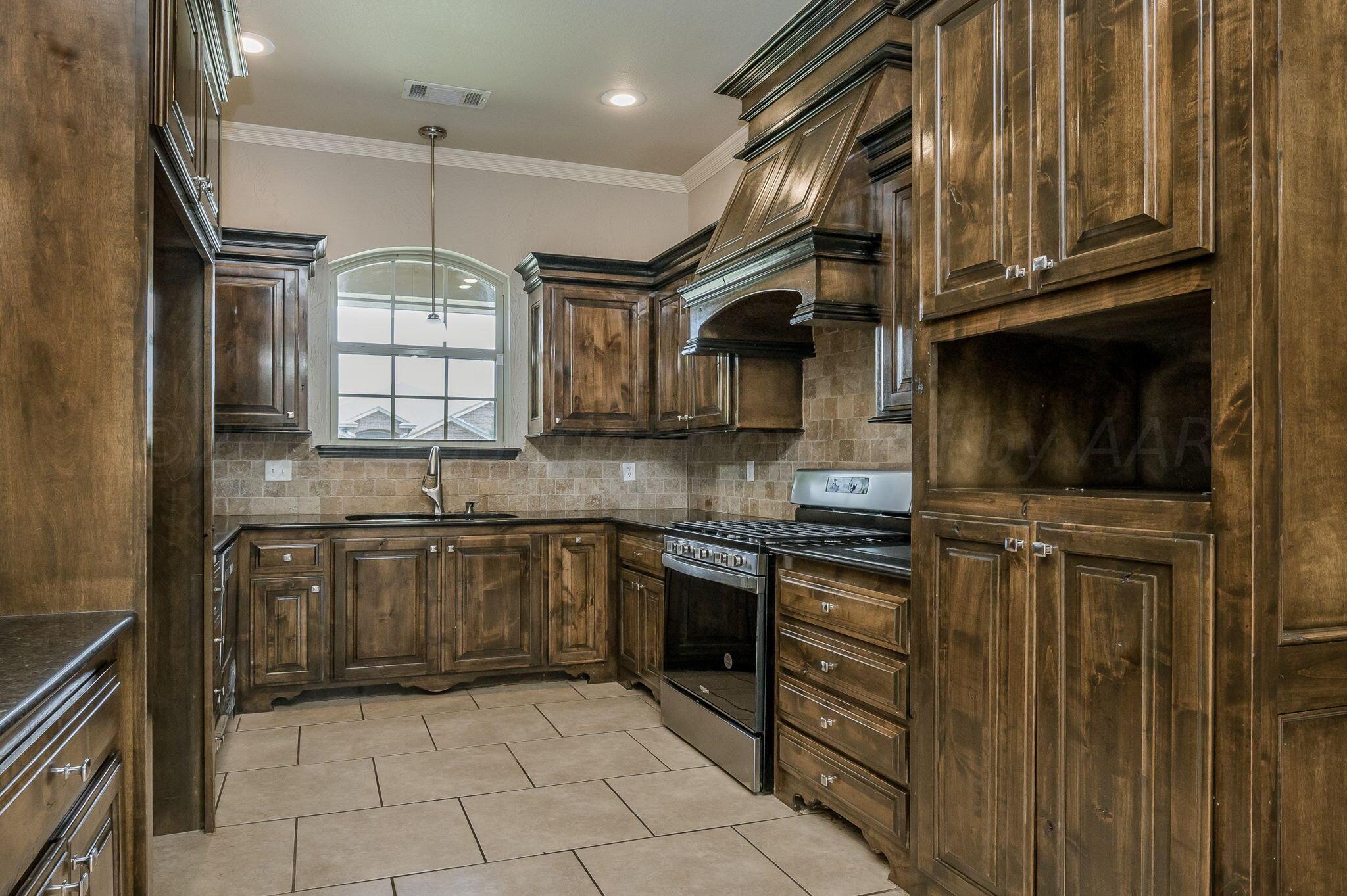 3601 Springfield Avenue Amarillo, TX 79118 - Photo 8 of 26 a kitchen with stainless steel appliances granite countertop a stove and cabinets