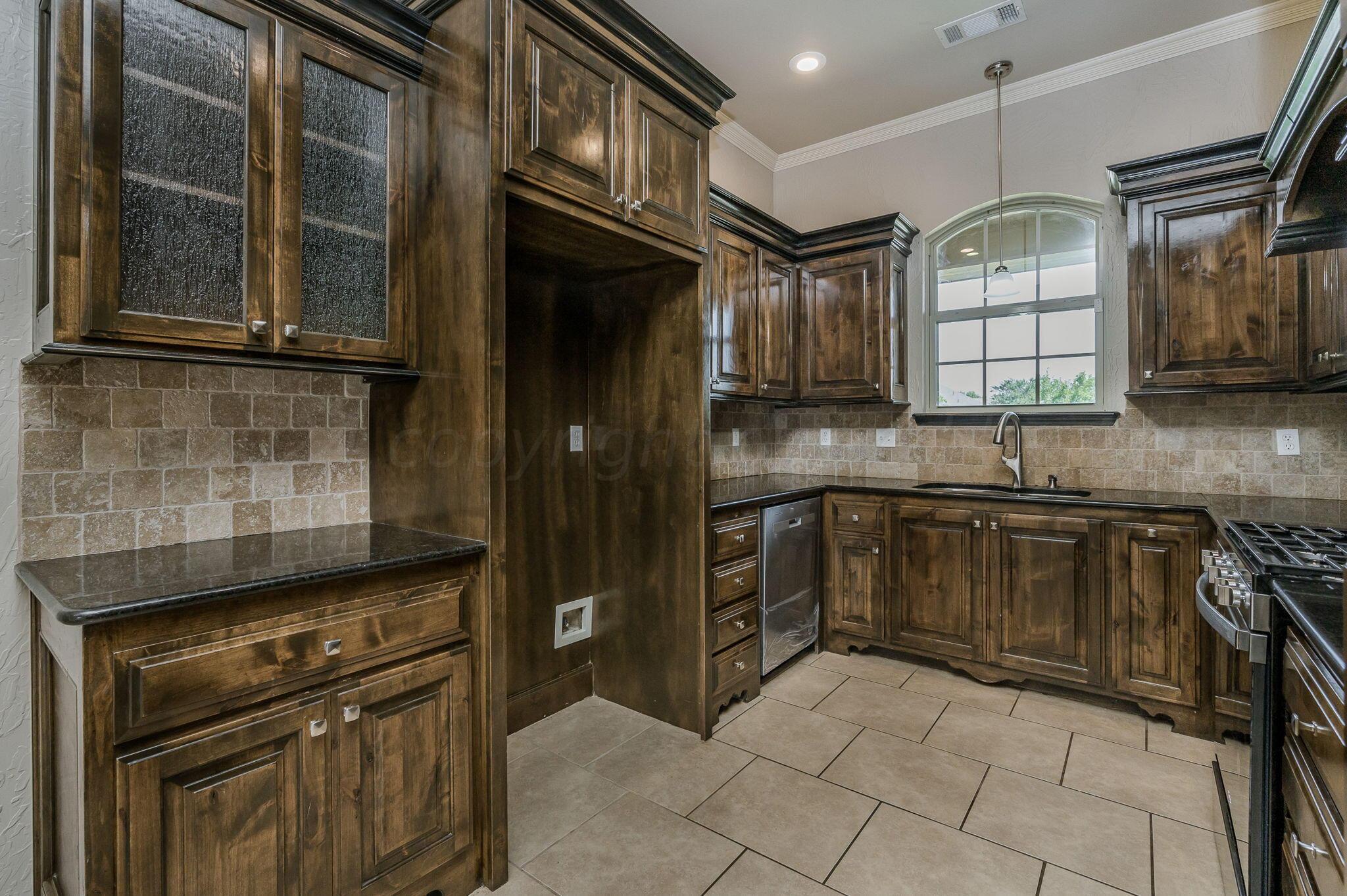 3601 Springfield Avenue Amarillo, TX 79118 - Photo 9 of 26 a kitchen with granite countertop a stove top oven cabinetry and a sink