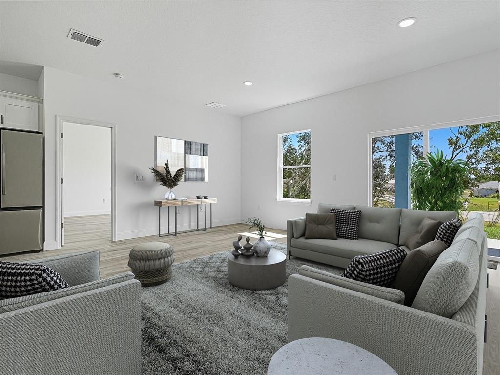 13322 Southwest 85th Circle Ocala, FL 34473 - Photo 21 of 27 a living room with furniture and a rug