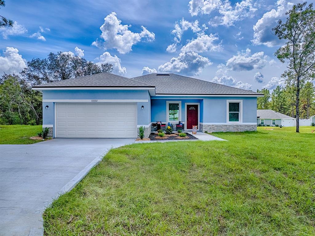 13322 Southwest 85th Circle Ocala, FL 34473 - Photo 27 of 27 a front view of house with yard and outdoor seating