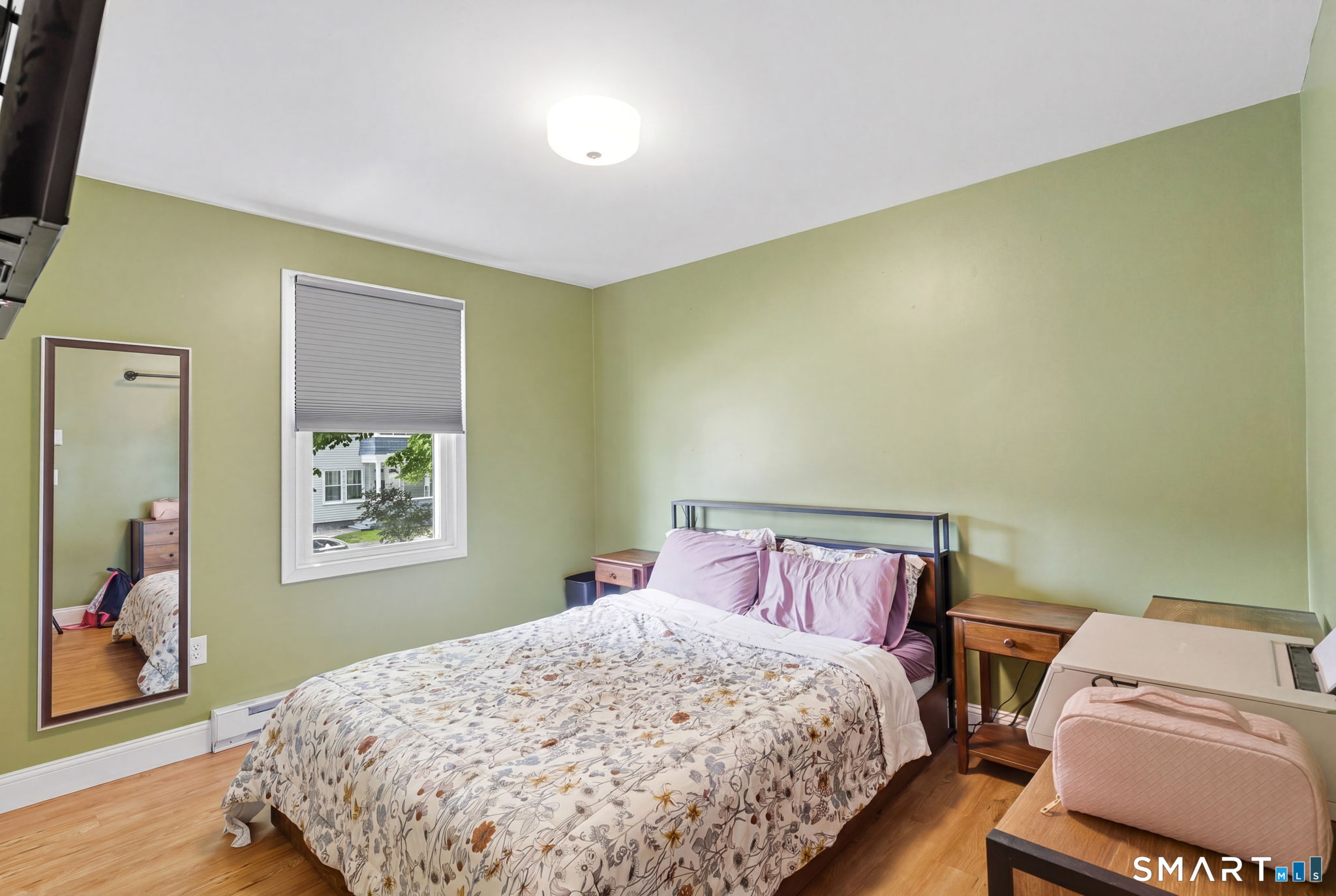 71 Smith Street Putnam, CT 06260 - Photo 3 of 25 a bedroom with a bed and wooden floor