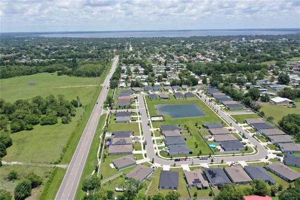 a view of a big yard of grass and an tree