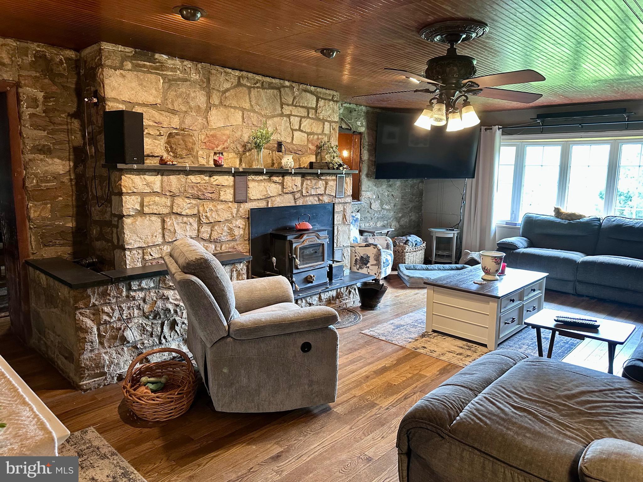107 Jalappa Road Hamburg, PA 19526 - Photo 8 of 42 a living room with furniture a fireplace and a flat screen tv