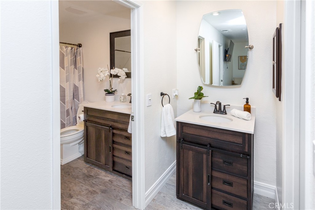 27668 Haskell Canyon Road, Unit H Saugus, CA 91350 - Photo 12 of 18 a bathroom with a sink and a mirror