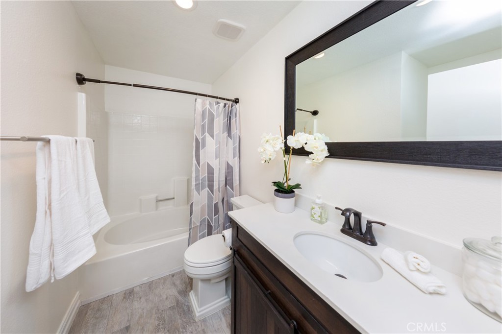 27668 Haskell Canyon Road, Unit H Saugus, CA 91350 - Photo 13 of 18 a bathroom with a sink toilet tub and shower