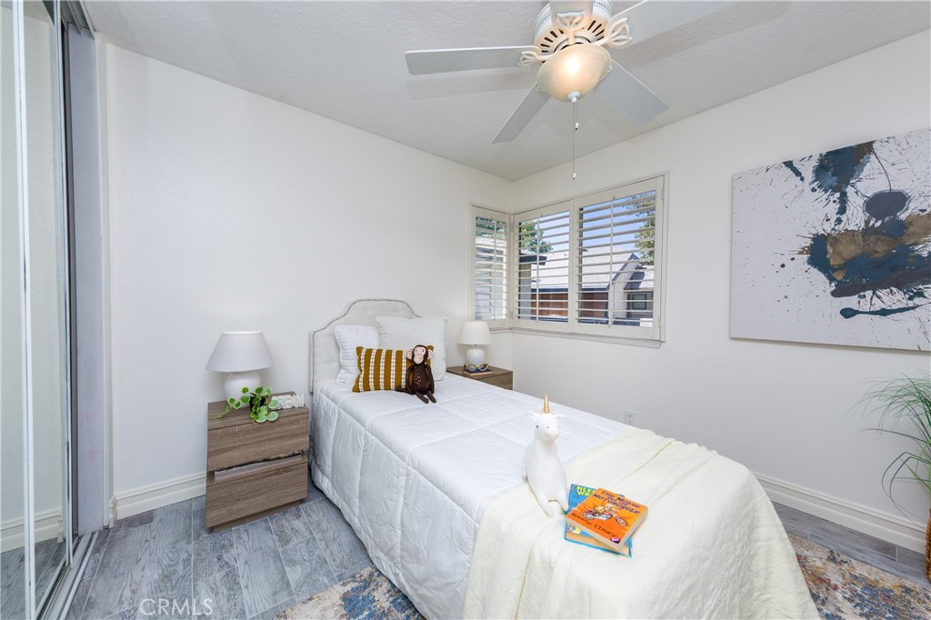 27668 Haskell Canyon Road, Unit H Saugus, CA 91350 - Photo 17 of 18 a bedroom with a bed and a chandelier