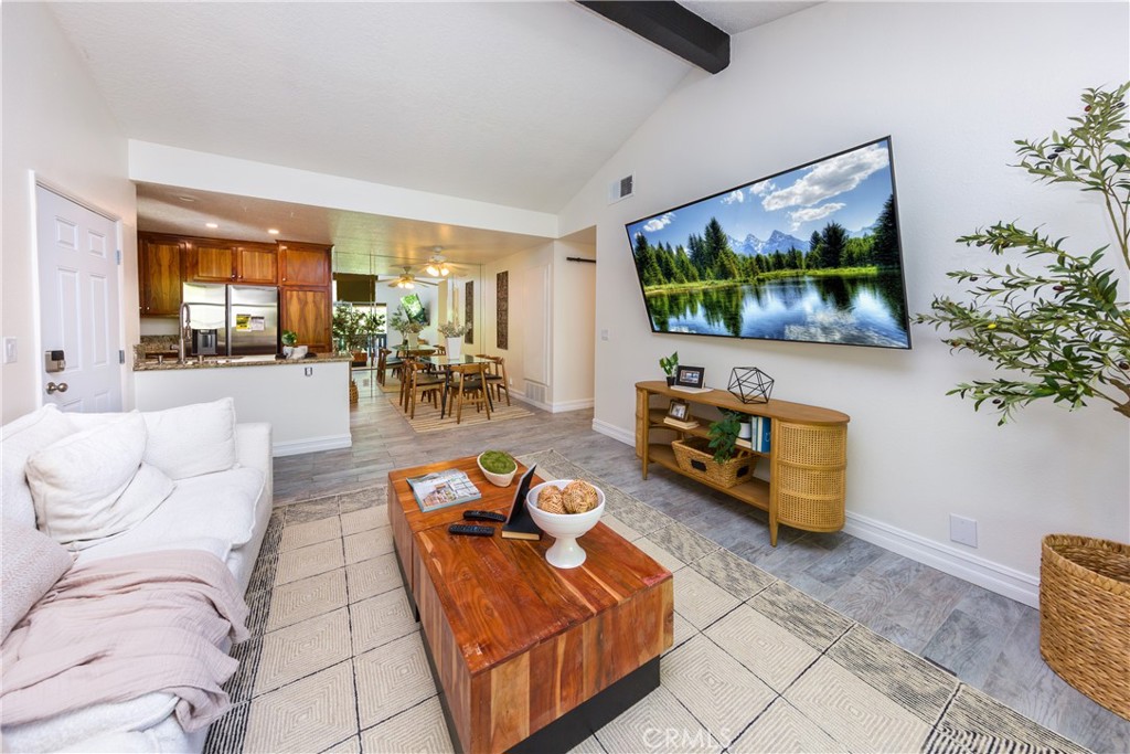 27668 Haskell Canyon Road, Unit H Saugus, CA 91350 - Photo 4 of 18 a living room with furniture and a flat screen tv