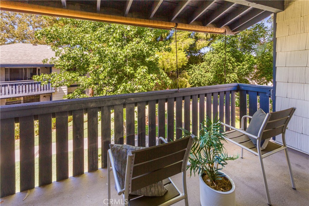 27668 Haskell Canyon Road, Unit H Saugus, CA 91350 - Photo 5 of 18 a view of a chair and table in the balcony