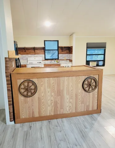 a view of kitchen with stainless steel appliances granite countertop cabinets and wooden floor