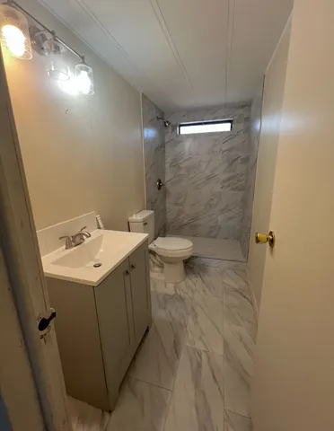 a view of bathroom with a sink and mirror