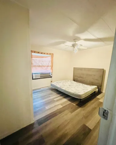 a view of a room with window and wooden floor