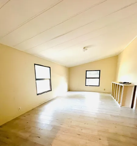 a view of kitchen with sink and refrigerator