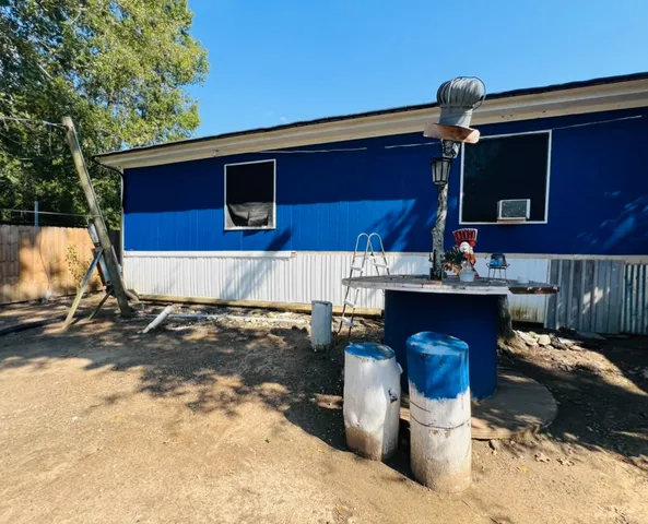 a view of a patio with a table and chairs under an umbrella