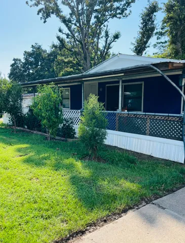 a view of a house with a yard and plants