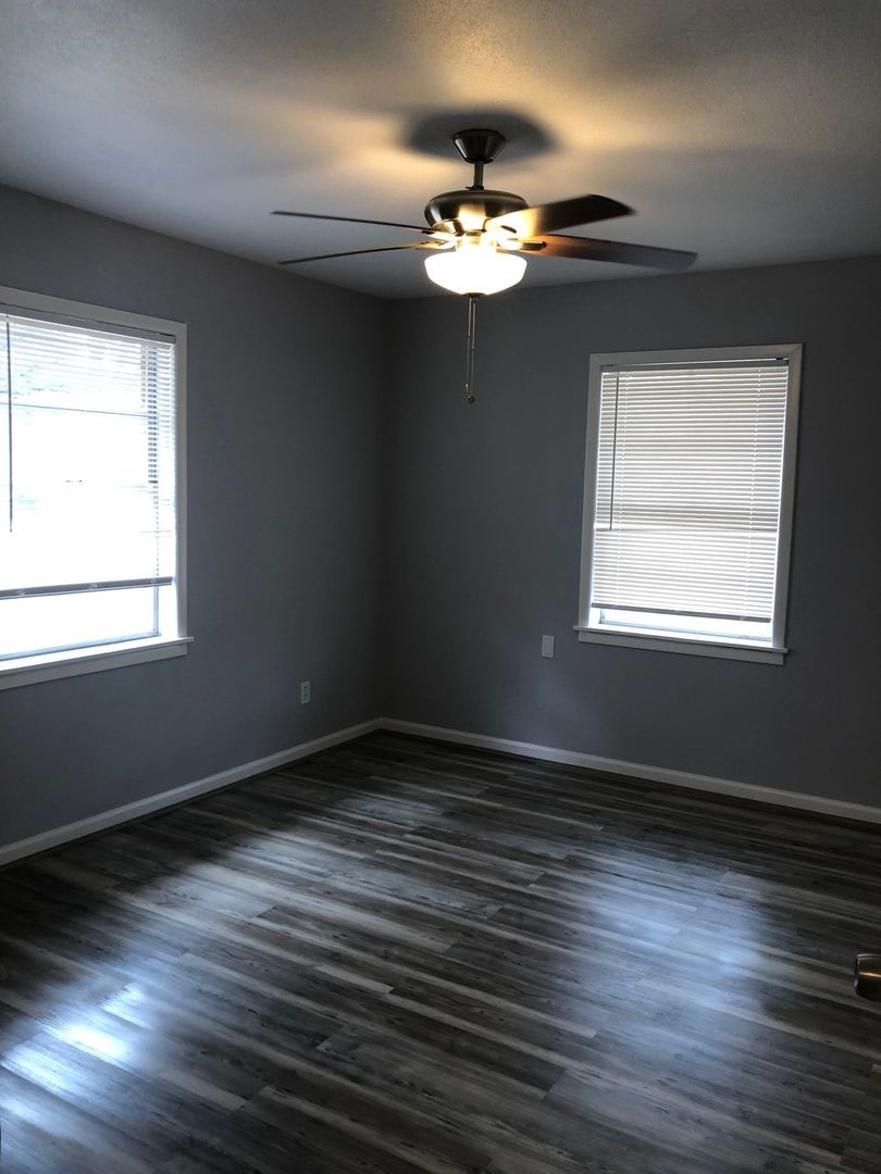 503 Willow Avenue Cleveland, TX 77327 - Photo 13 of 17 a view of an empty room with wooden floor and a window