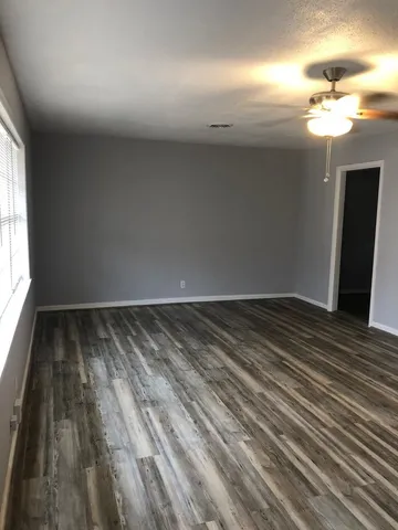 a view of a room with wooden floor