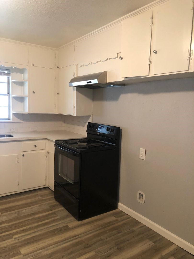 503 Willow Avenue Cleveland, TX 77327 - Photo 6 of 17 a kitchen with a sink and cabinets