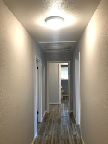 a view of hallway with wooden floor