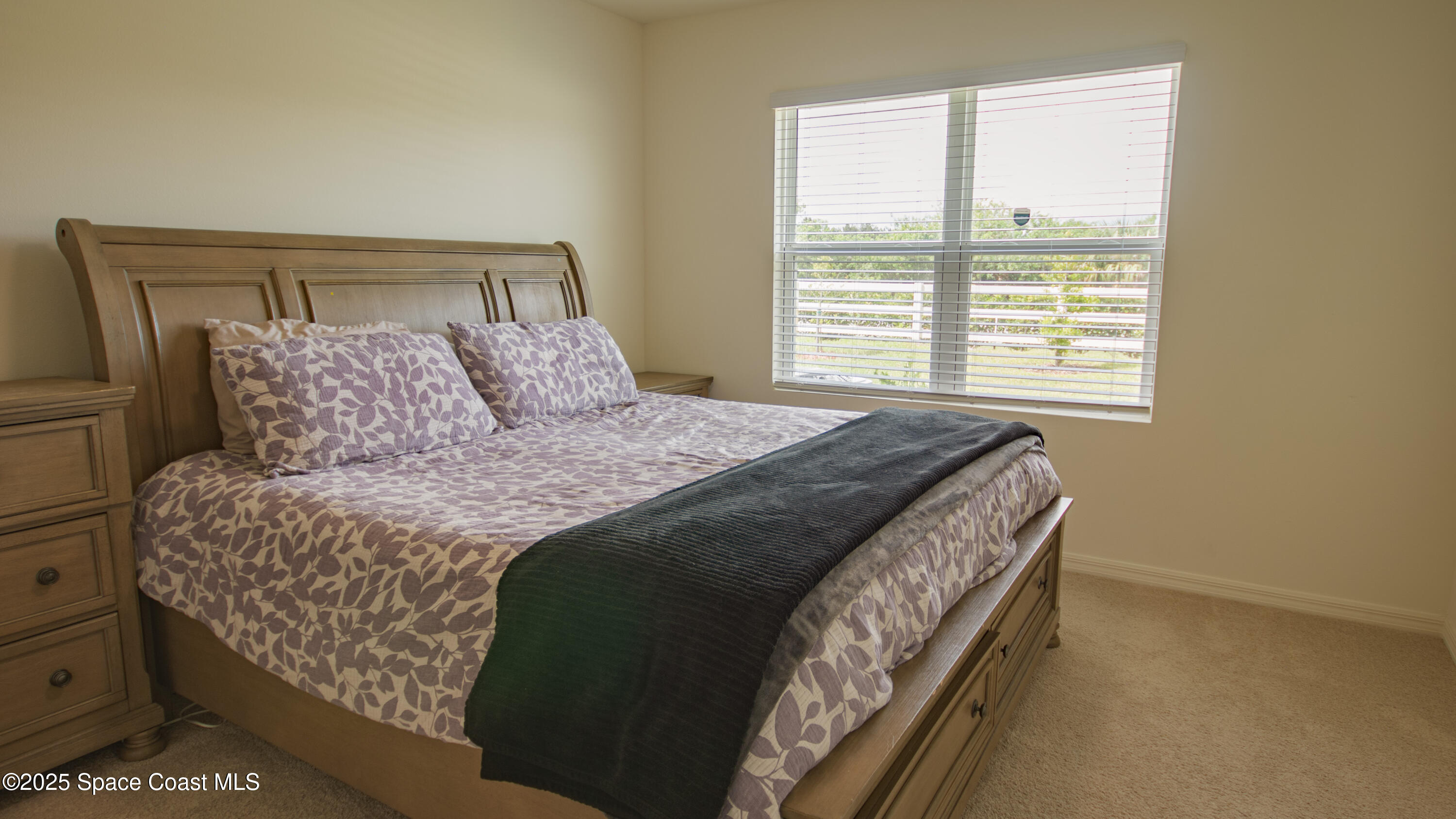 913 Trinity Street Rockledge, FL 32955 - Photo 12 of 25 a bed sitting in a bedroom next to a window