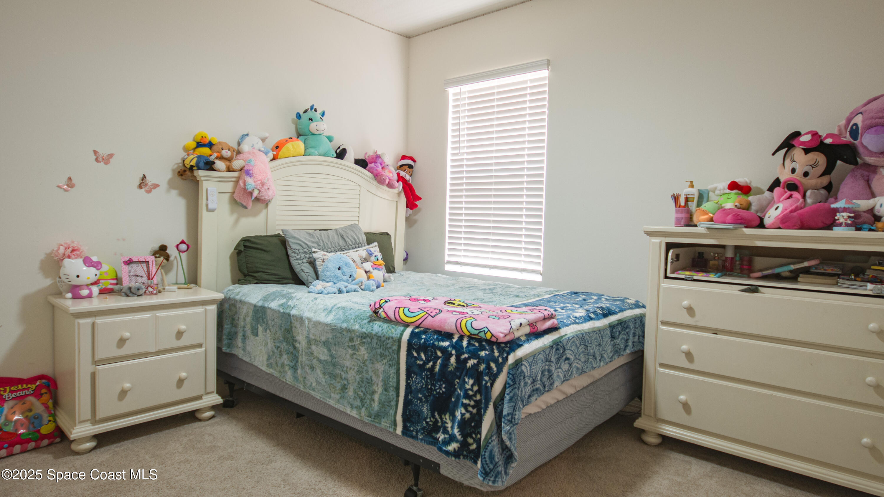 913 Trinity Street Rockledge, FL 32955 - Photo 16 of 25 a bedroom with a bed and a dresser