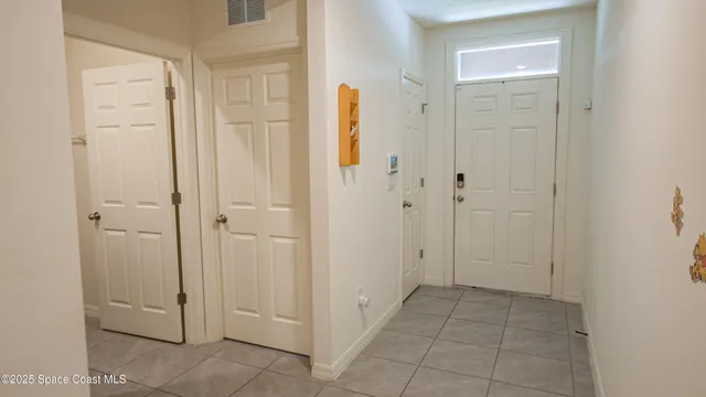 a view of a hallway with closet and a bathroom