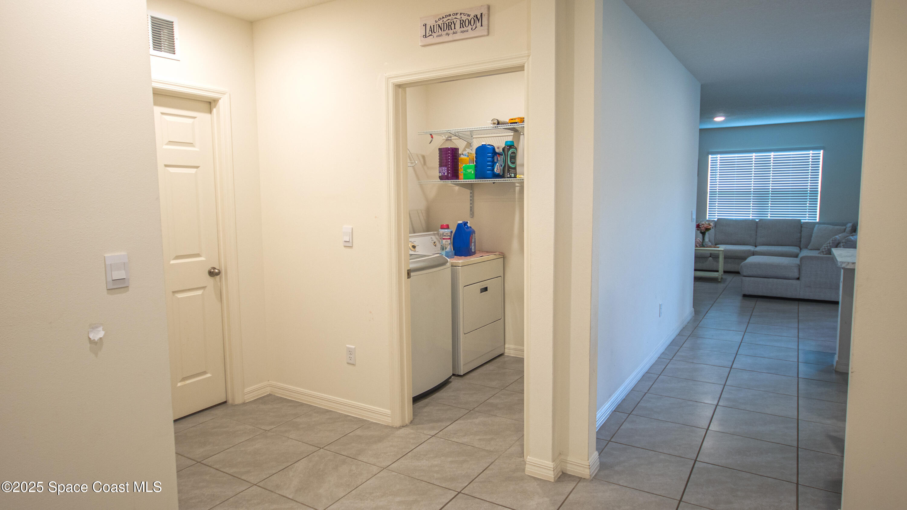 913 Trinity Street Rockledge, FL 32955 - Photo 4 of 25 a view of a hallway with closet and a bathroom