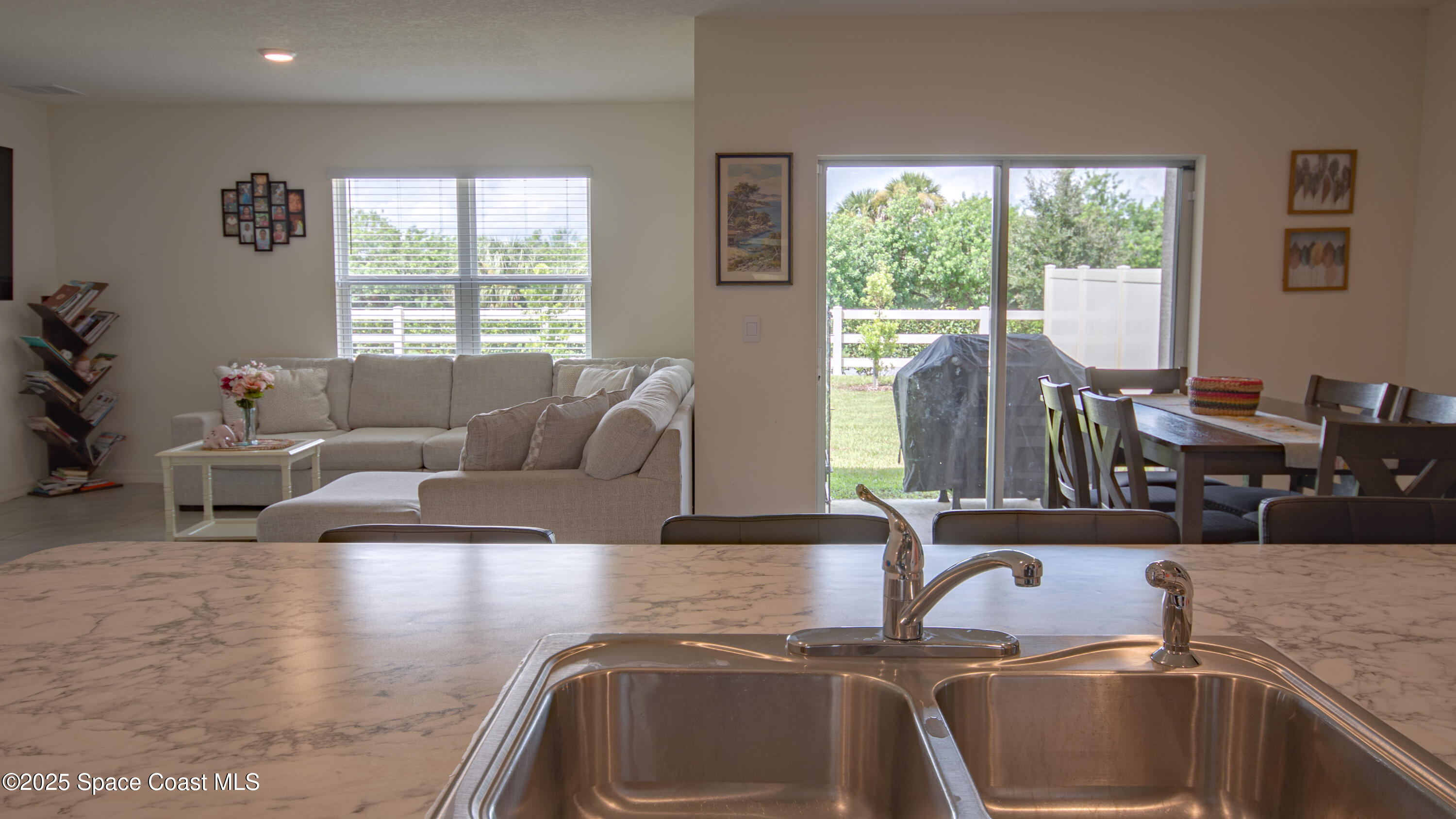 913 Trinity Street Rockledge, FL 32955 - Photo 6 of 25 a living room with furniture and a large window