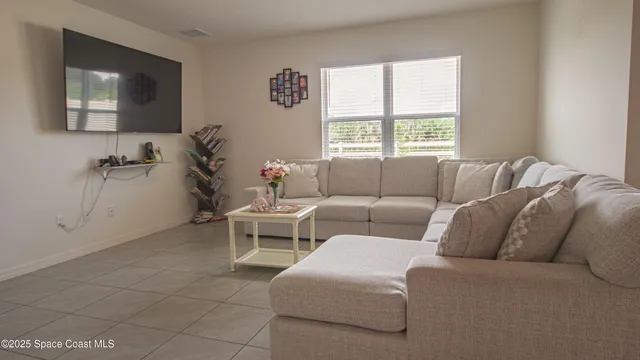 a kitchen with stainless steel appliances kitchen island granite countertop a refrigerator a stove a sink a dining table and chairs with wooden floor