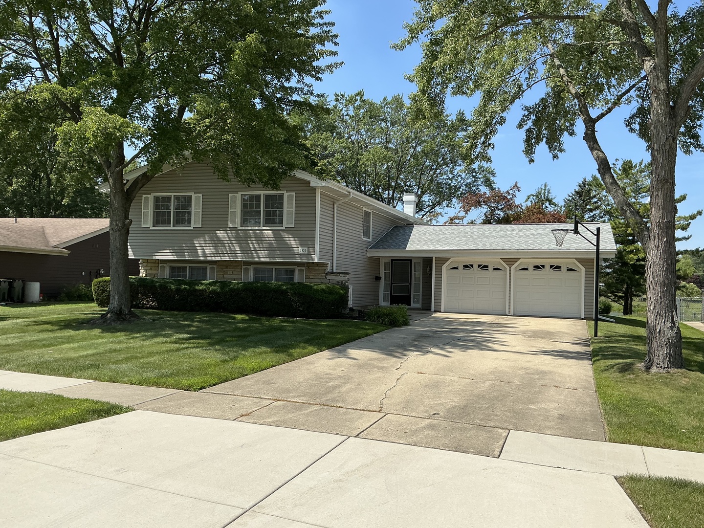 a front view of house with a garden