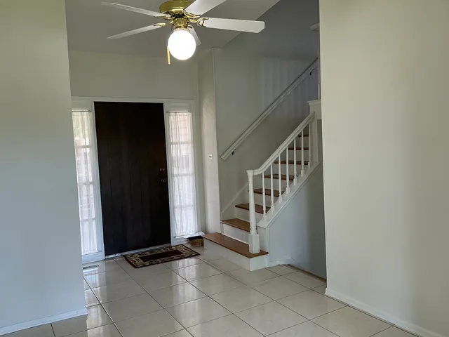 a view of an entryway with wooden floor and staircase