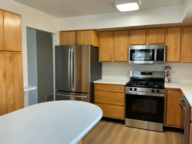 a kitchen with a stove microwave and refrigerator