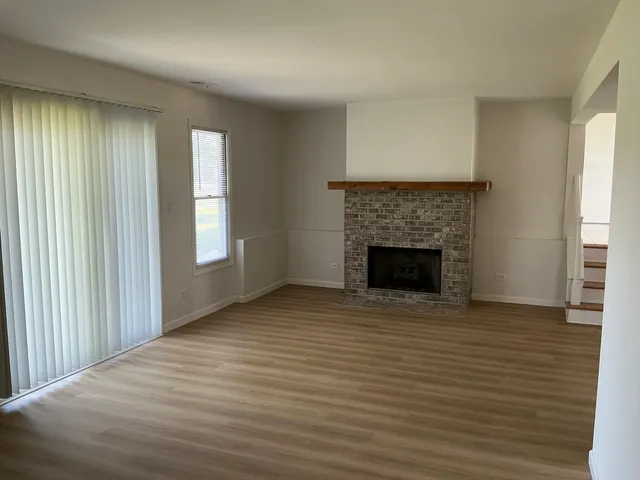 wooden floor fireplace and windows in a room