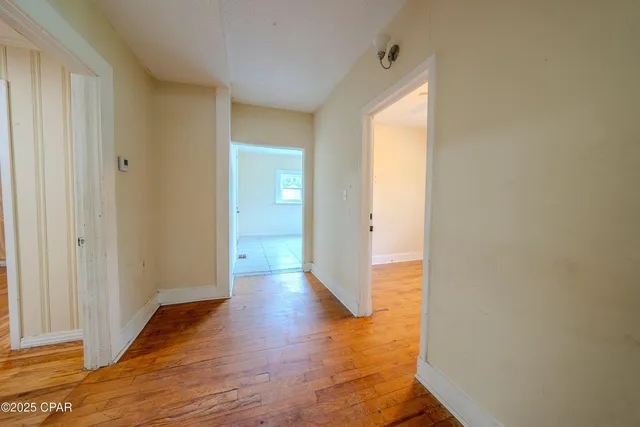 a view of a hallway with wooden floor