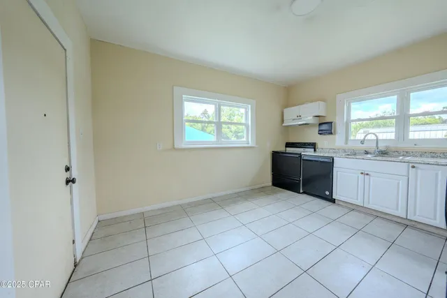 a view of a kitchen with sink cabinets and window