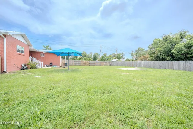 a view of a room with wooden floor and a window