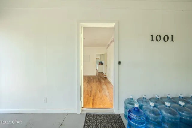 a kitchen with wooden floors and white cabinets