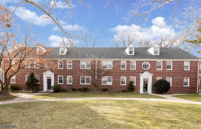 a front view of a building with a yard