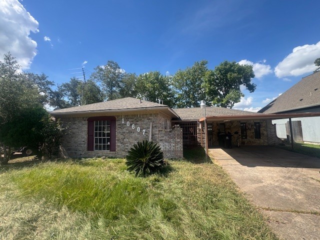 a view of a house with a yard and potted plants