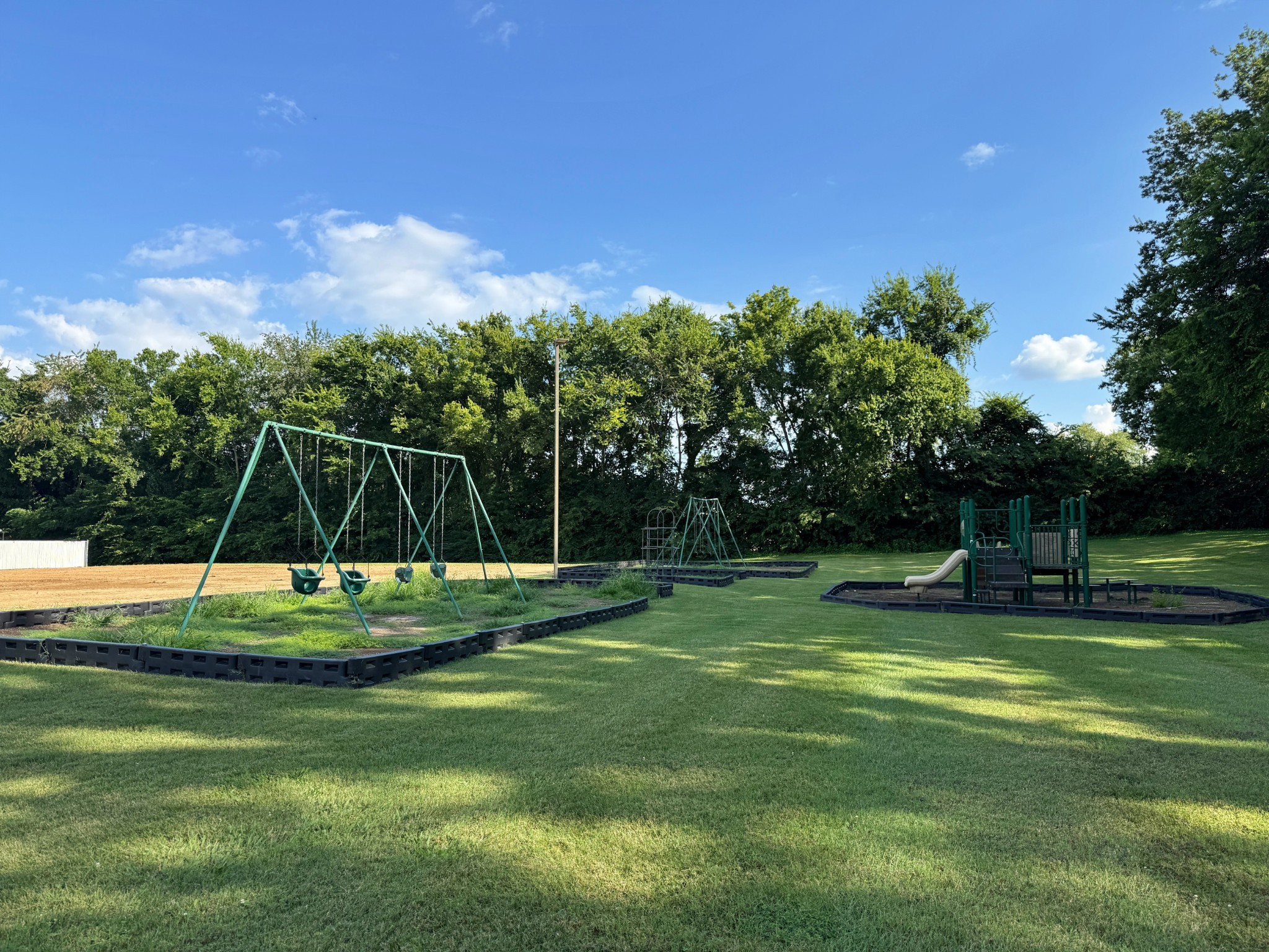 1702 Granville Road Franklin, TN 37064 - Photo 24 of 26 a view of a playground with a slide and swing