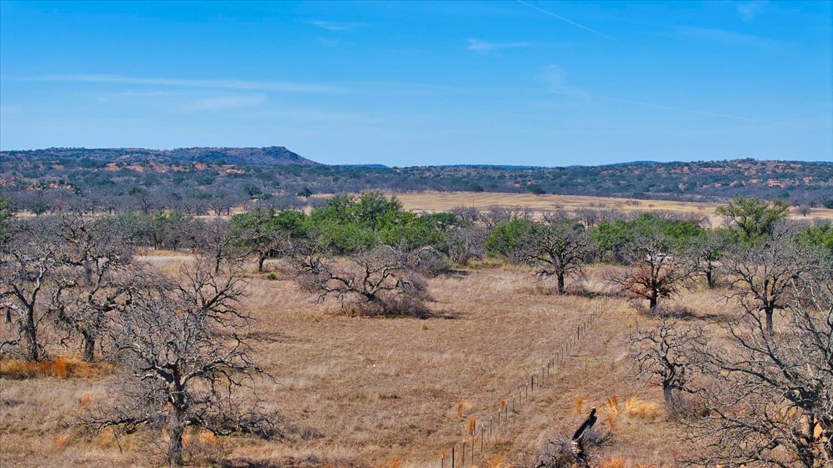 17431 Hickory Grove Road Pontotoc, TX 76869 - Photo 15 of 31 a view of a dry yard with mountains in the background