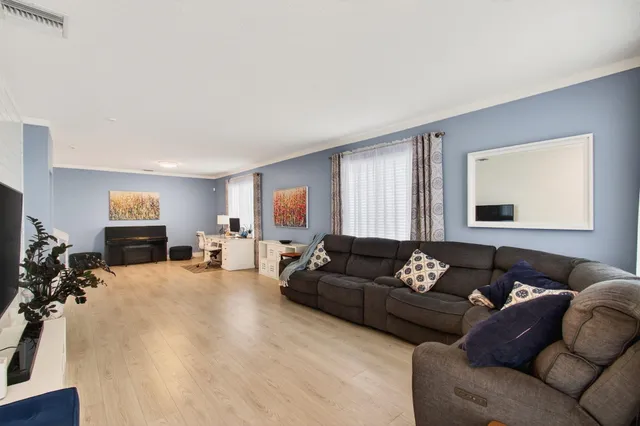 a living room with furniture window and a couch