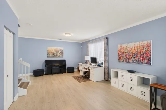 a bedroom with furniture and a flat screen tv